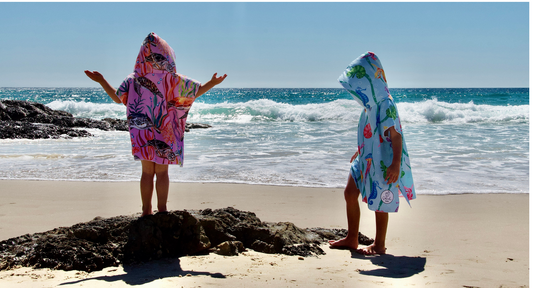Here is a great photo of 2 kids at Currumbin Beach Queensland with their Sustainable Beach Essential Sand Free Hoodies, one is wearing a small Turtle Cove and the other Eartha and Sea each come in various sizes small or medium or large