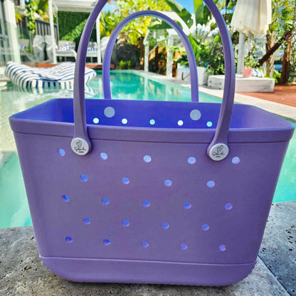 Purple Coral Cove Silicone Bag: Poolside Essentials in Style. [Vibrant purple Coral Cove silicone bag sits poolside, perfect for keeping your swim essentials organised and within reach.]