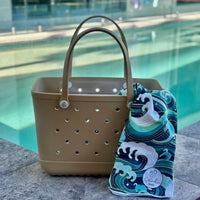 Sand Eva Silicone bag showing the a Wipeout Sand Free Hoodie for kids and adults.