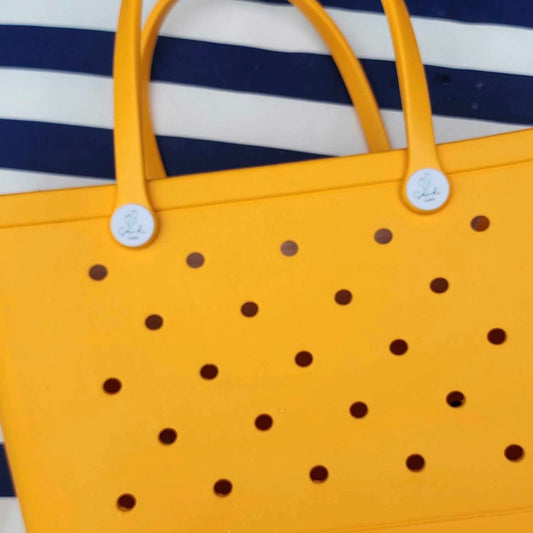 Yellow Summer Bag: Beach Style for Sunny Days. [Cheerful yellow summer bag rests on a blue and white striped beach towel, perfect for carrying your beach essentials in style.]