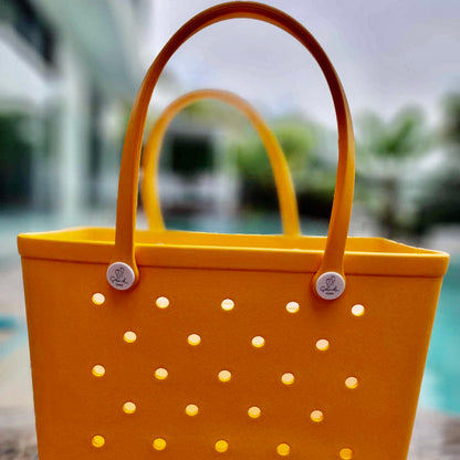 Yellow Summer Bag: Poolside Fun in Style. [Eye-catching yellow summer bag sits beside a refreshing pool with a blurred background, perfect for carrying your poolside essentials.]