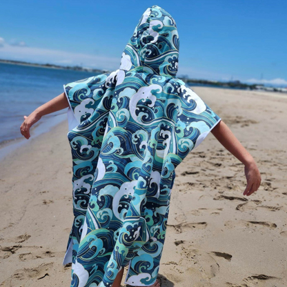 Boy with arms outstretched on Hastings Point Beach
