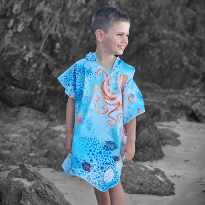 Under The Sea Sand Free Beach Towel as shown on a boy aged 5 years old, standing on the sand at Currumbin Beach Queensland 