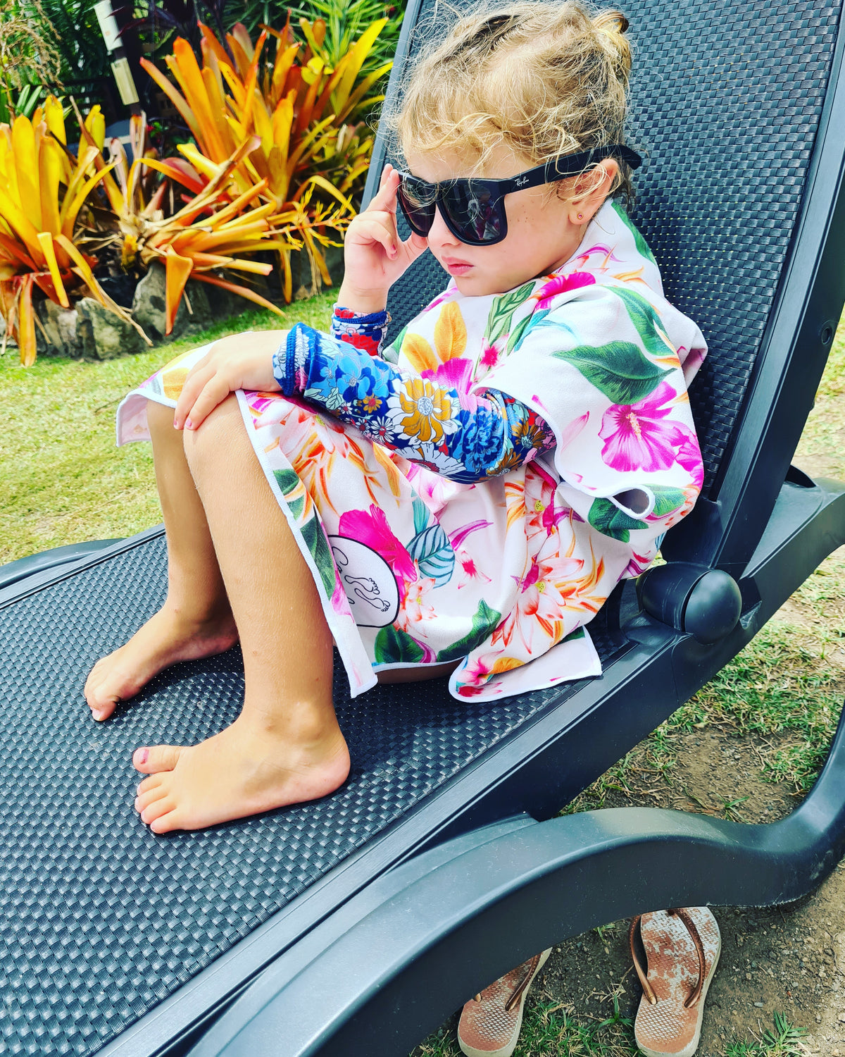 Laugh out loud a small child is hiding behind a pair of her fathers sunglasses in her Island Princess sand free hoohed beach towel