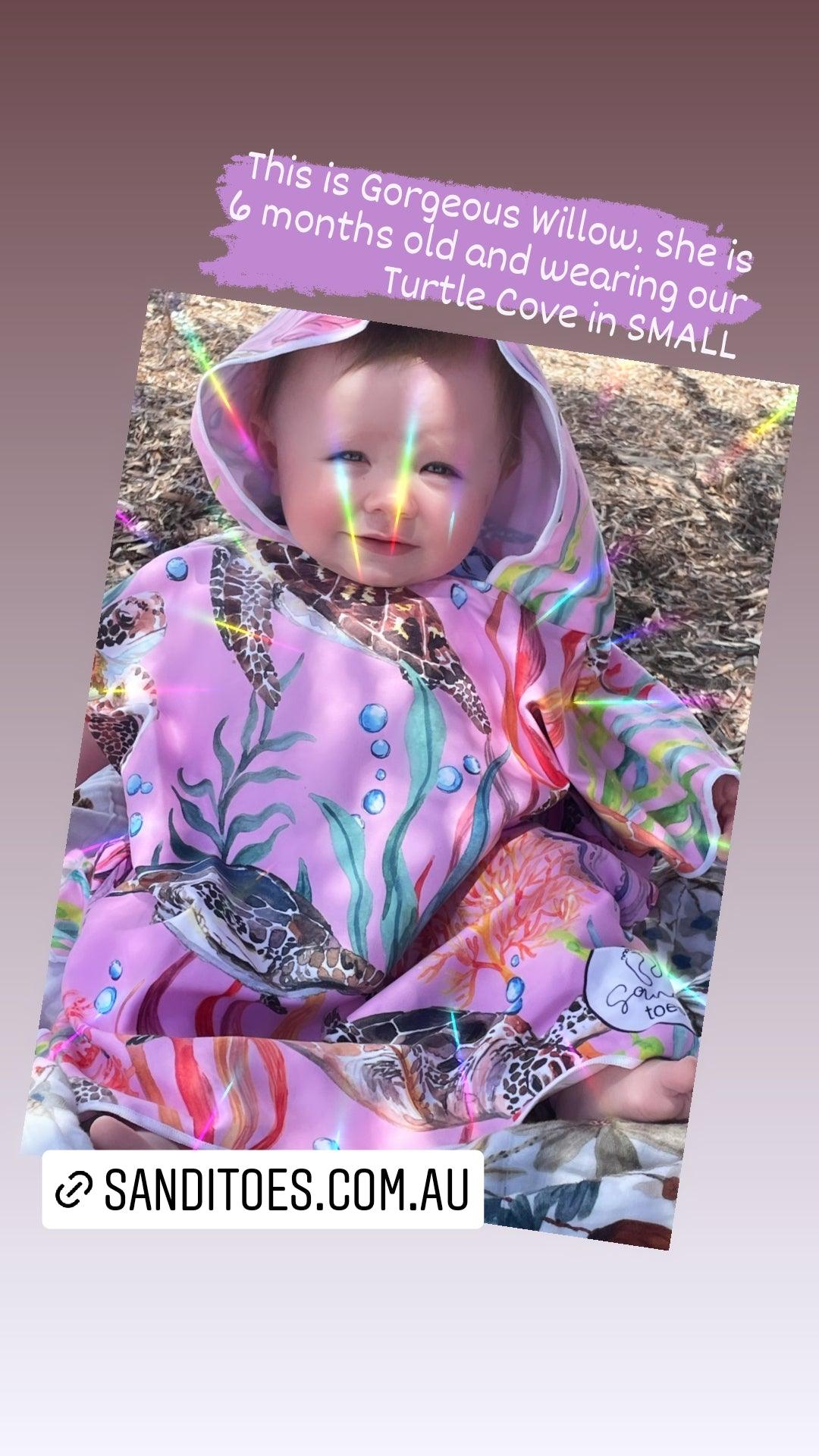 Baby in our Turtle Cove Sand Free Hooded Beach Towel