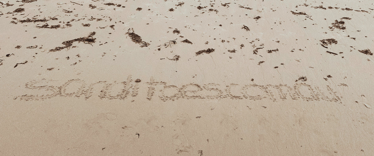 Sandi Toes written in the sand on Catseye beach on Hamilton Island