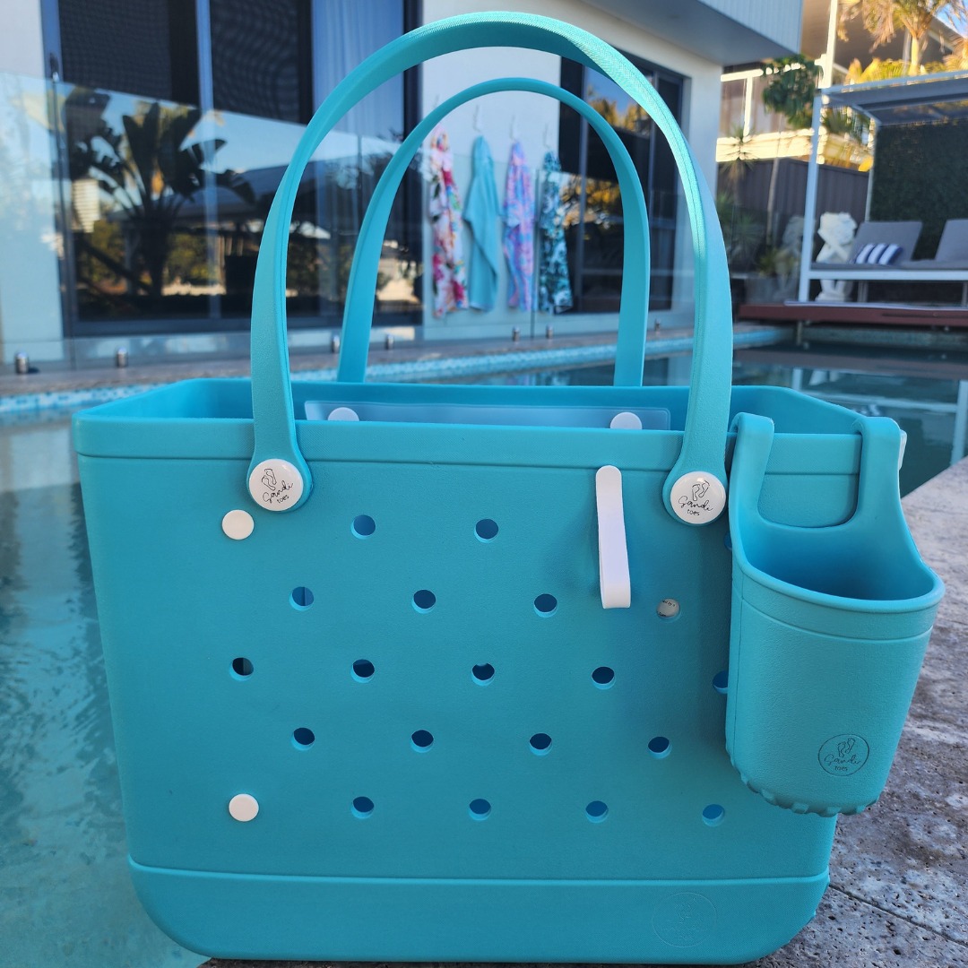 Aqua Marine EVA tote bag with a small pouch cup holder and clip on a reflective surface