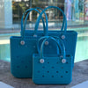  "All three Aqua Marine EVA silicone beach tote bags front view The Hauler, The Everyday and The Mini, showing size, Sandi Toes buttons, and sturdy handles"