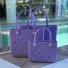 * "All three Coral Cove EVA silicone beach tote bags front view The Hauler, The Everyday and The Mini, showing size, Sandi Toes buttons, and sturdy handles"