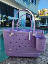 Coral Cove Tote Bag with Silicone Cup holder and key clip beside a swimming pool