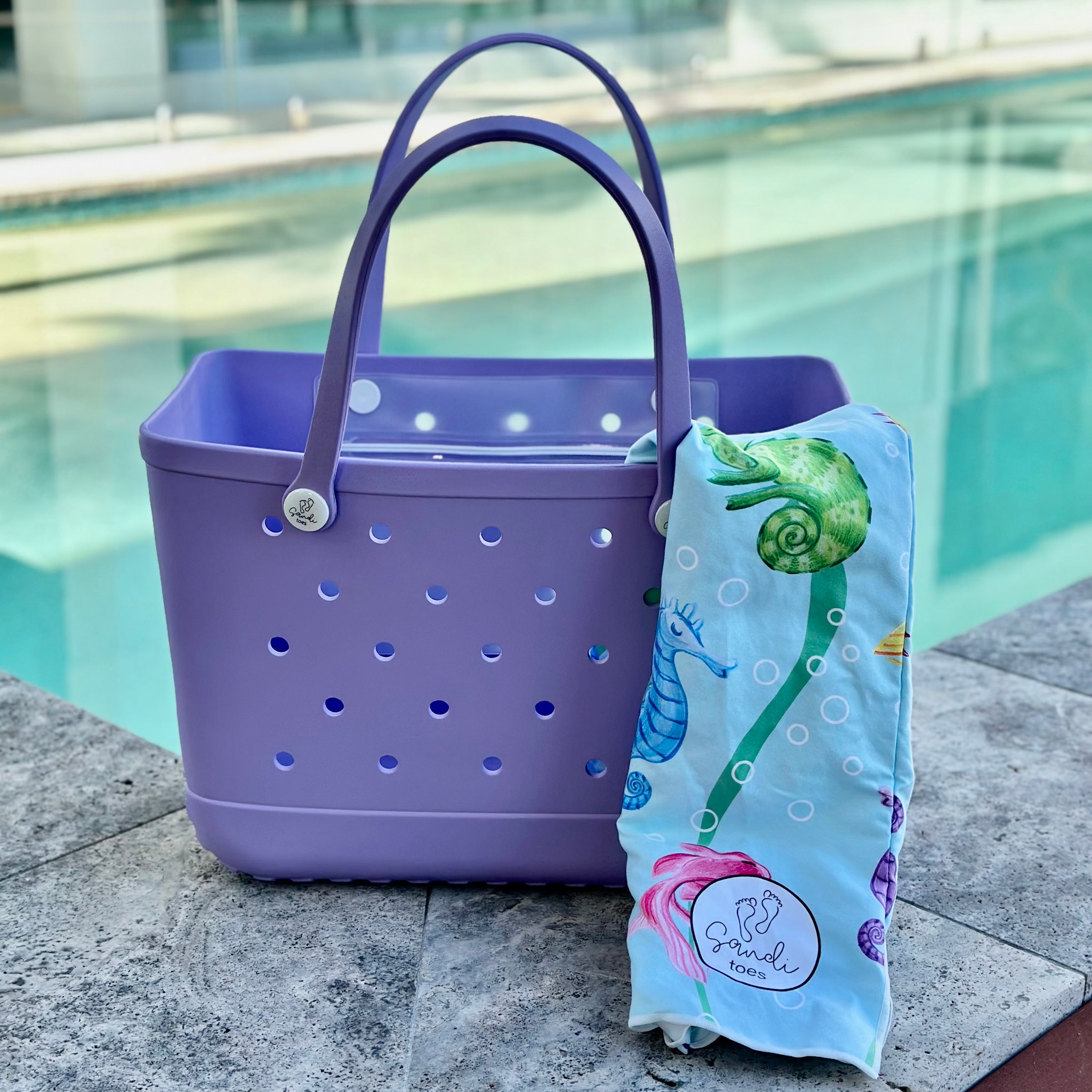 * "Coral Cove Eva Silicone bag showing the a Earth and Sea Sand Free Hoodie for kids."