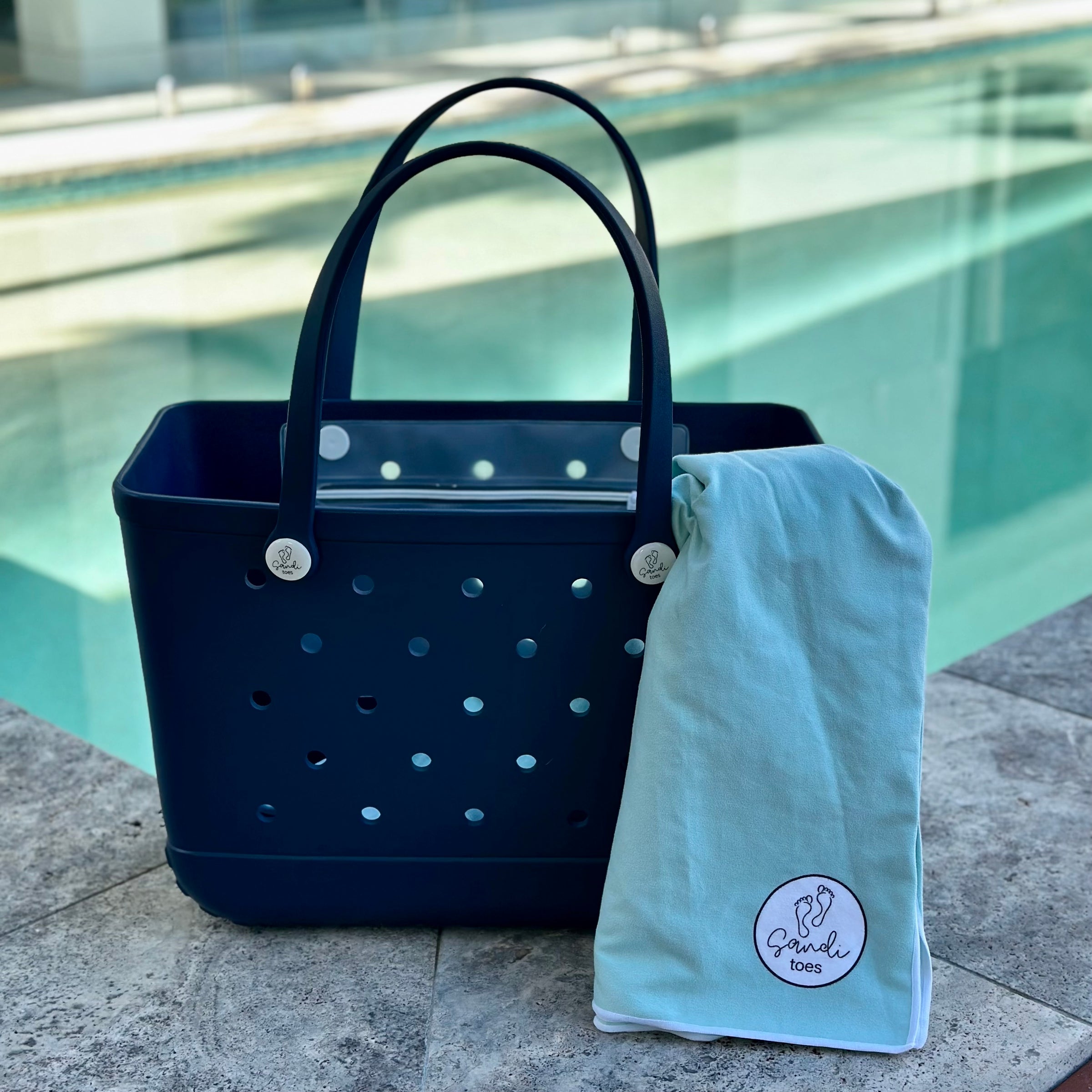  "Sailors Navy Eva Silicone bag showing the a Aqua Lagoon Sand Free Hoodie for adults"
