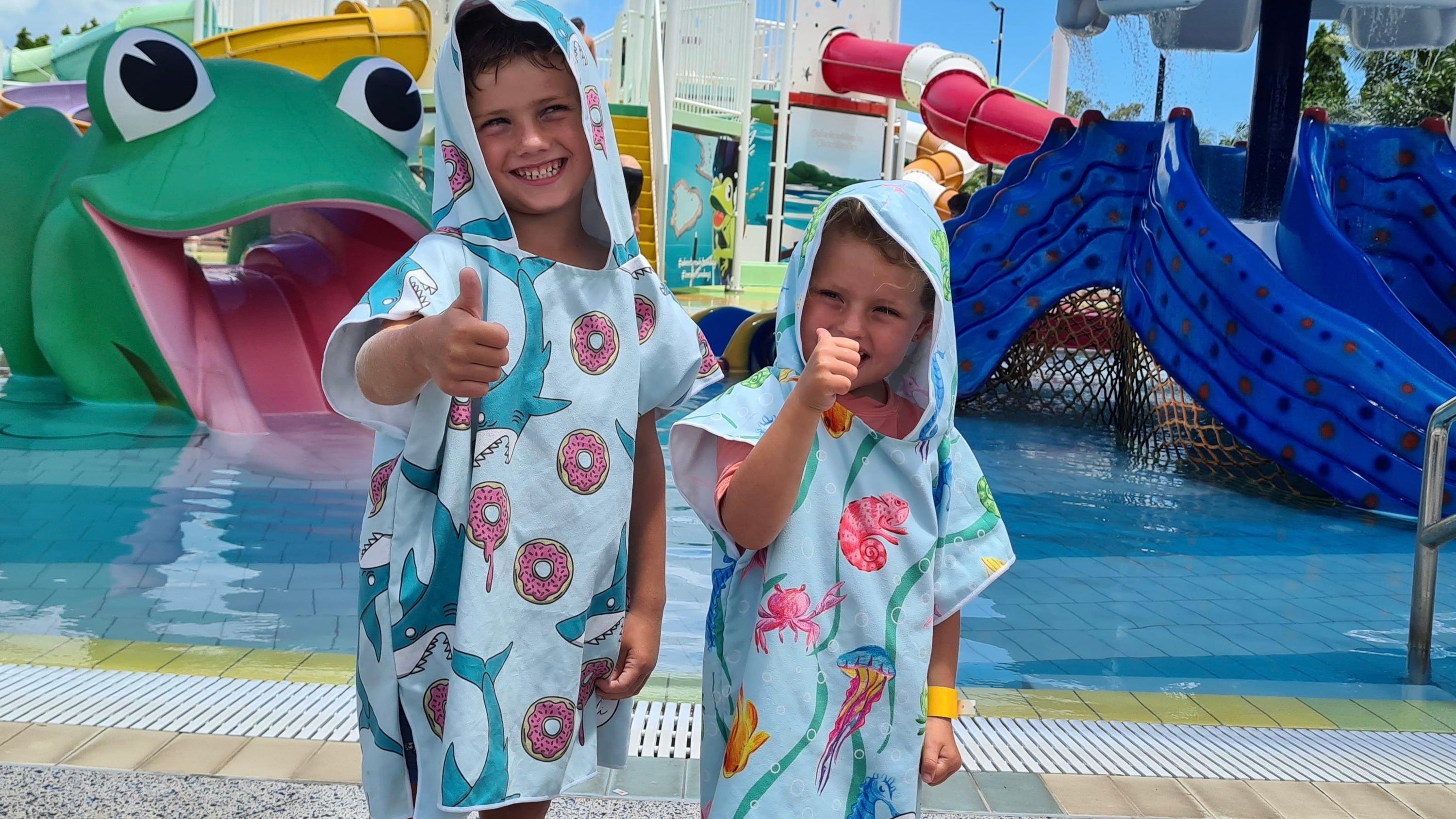These two kids wearing Sandi Toes hoodies enjoying their day at Airlie Beach Water Slide Park