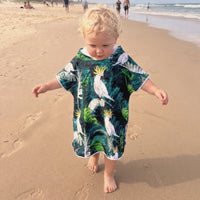 toddler walking on the beach wearing babies to 3 age sand free hooded towel