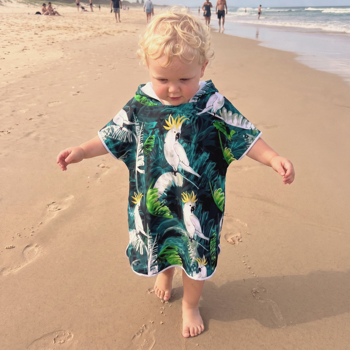 toddler walking on the beach wearing babies to 3 age sand free hooded towel